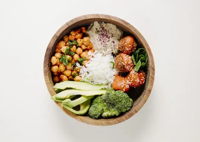 meatballs-rice-beans-broccoli-inside-wooden-bowl.webp