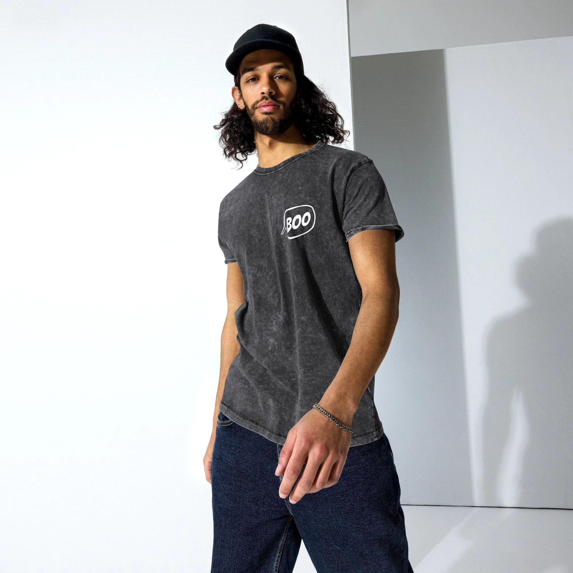 Man in a laid back pose wearing a Pedestrian Brand, Boo Design urban tee in grey.