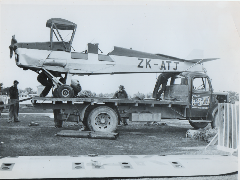 Tiger-Moth-appears-to-have-had-a-mishap-and-Transport-Wairarapas-Bedford-is-called-upon-to-carry-it-away.png