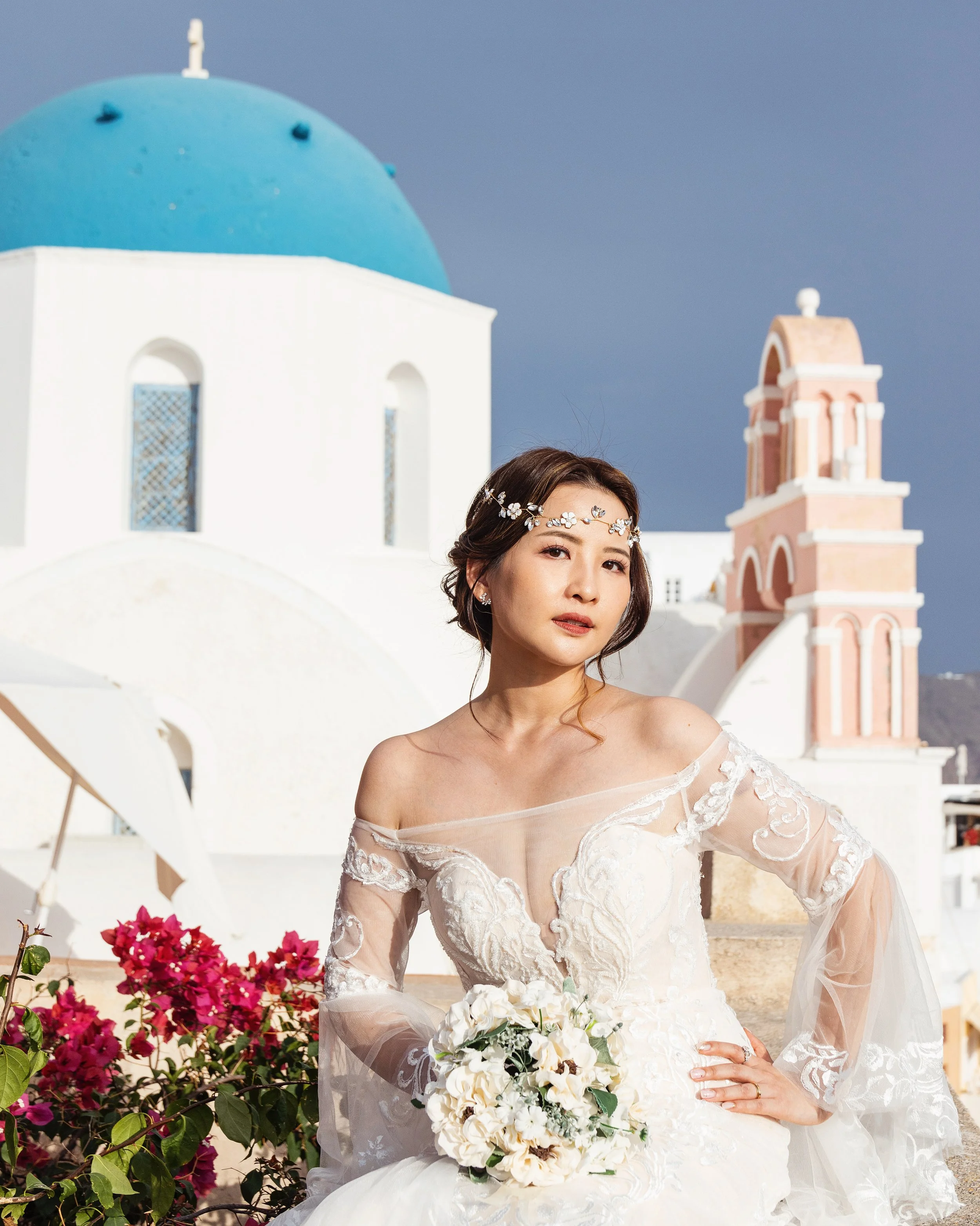 Santorini wedding photography aerial drone panorama over the caldera showing an intimate elopement couple on cliff edge with sweeping Aegean views.