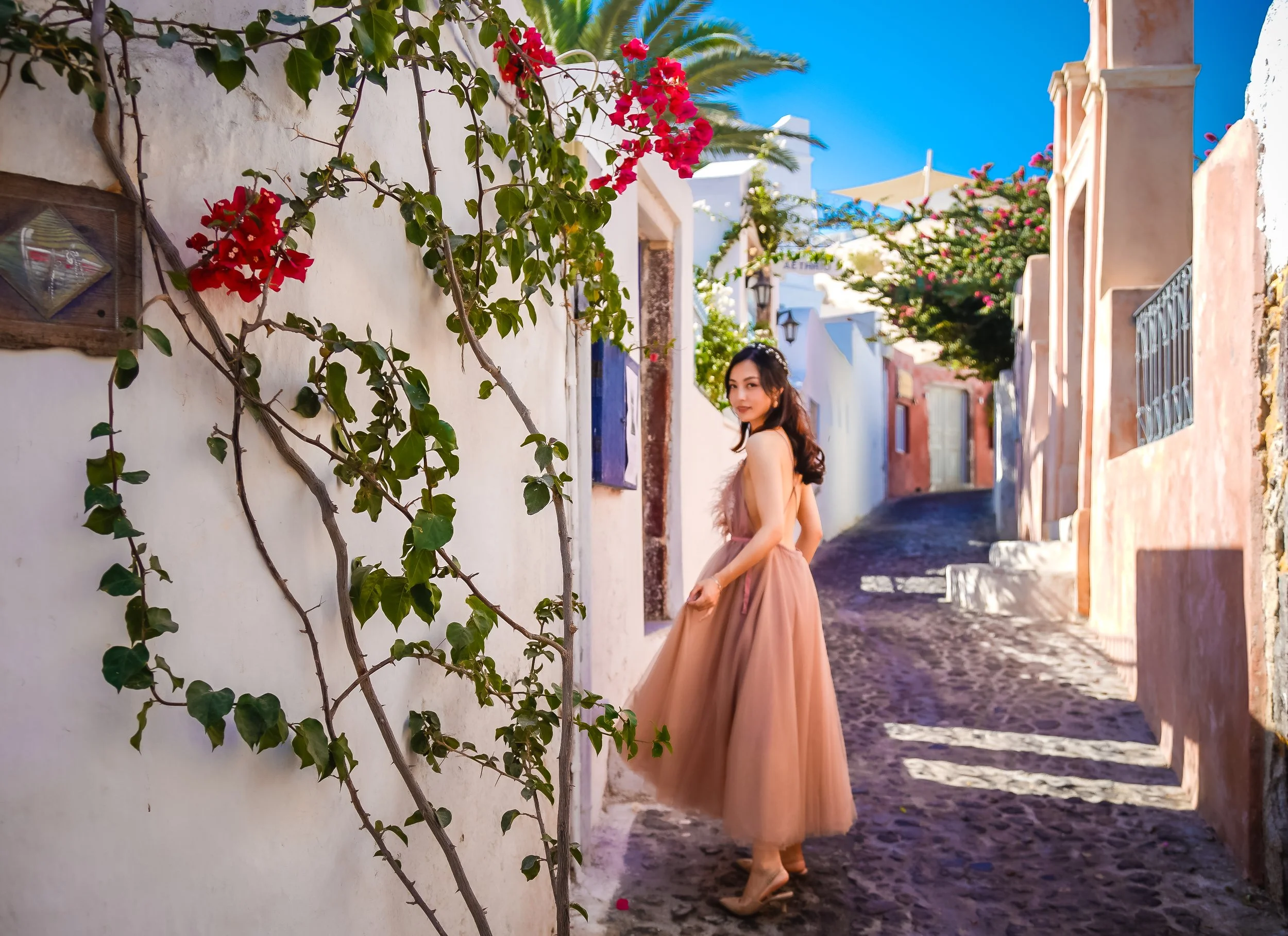 Santorini wedding photography bridal prep in a cave suite interior using window light for soft editorial portraits and natural detail shots.