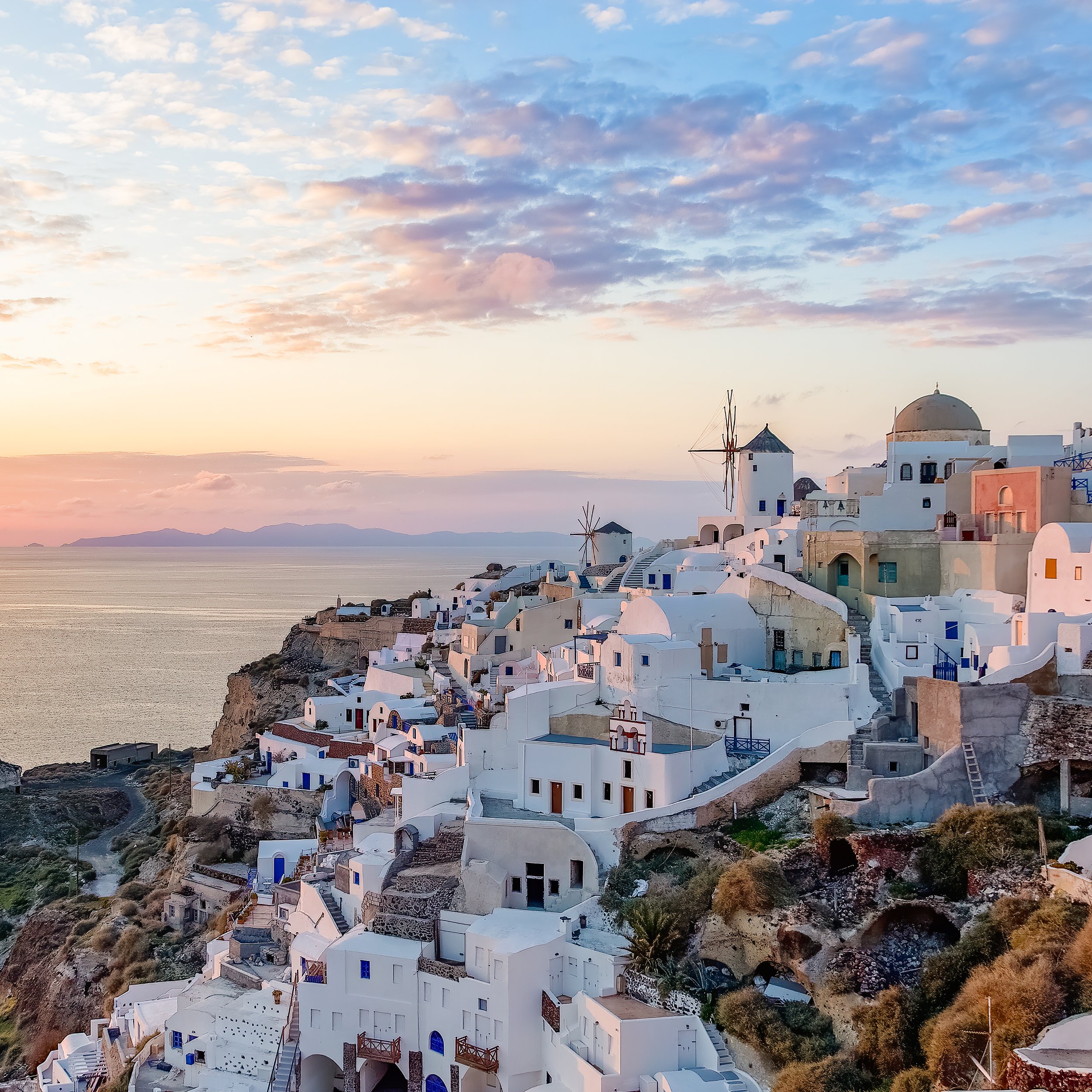 Blue hour city lights and caldera glow in Fira — Santorini twilight photography tips and exposure settings. Fira 藍調時段城市燈光與海灣色澤 — Santorini 黃昏攝影曝光與技巧。