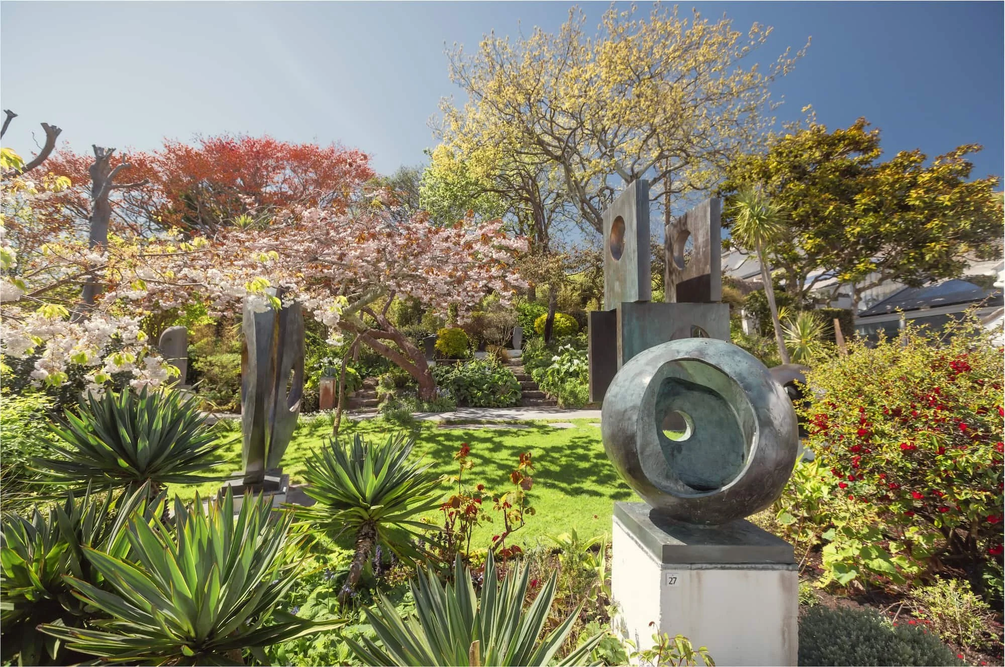 Hepworth garden in spring with cherry blossom and fresh foliage on mature trees