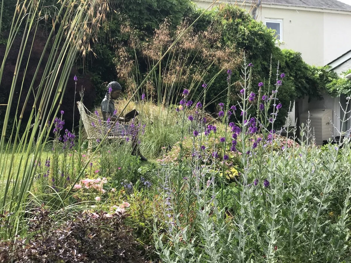 Perennia garden with sculpture perovskia tom thumb stipa gigantea