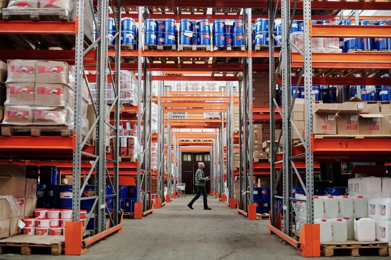 A person walking through an industrial inventory room