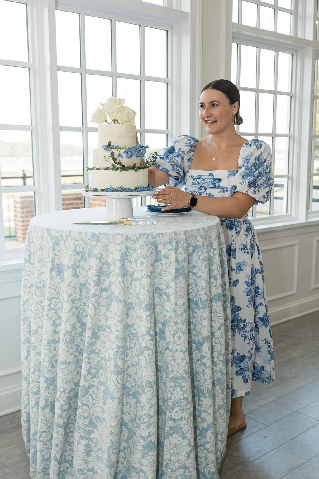 paige standing by cake- wedding at The Ospreys in Woodbridge Virginia