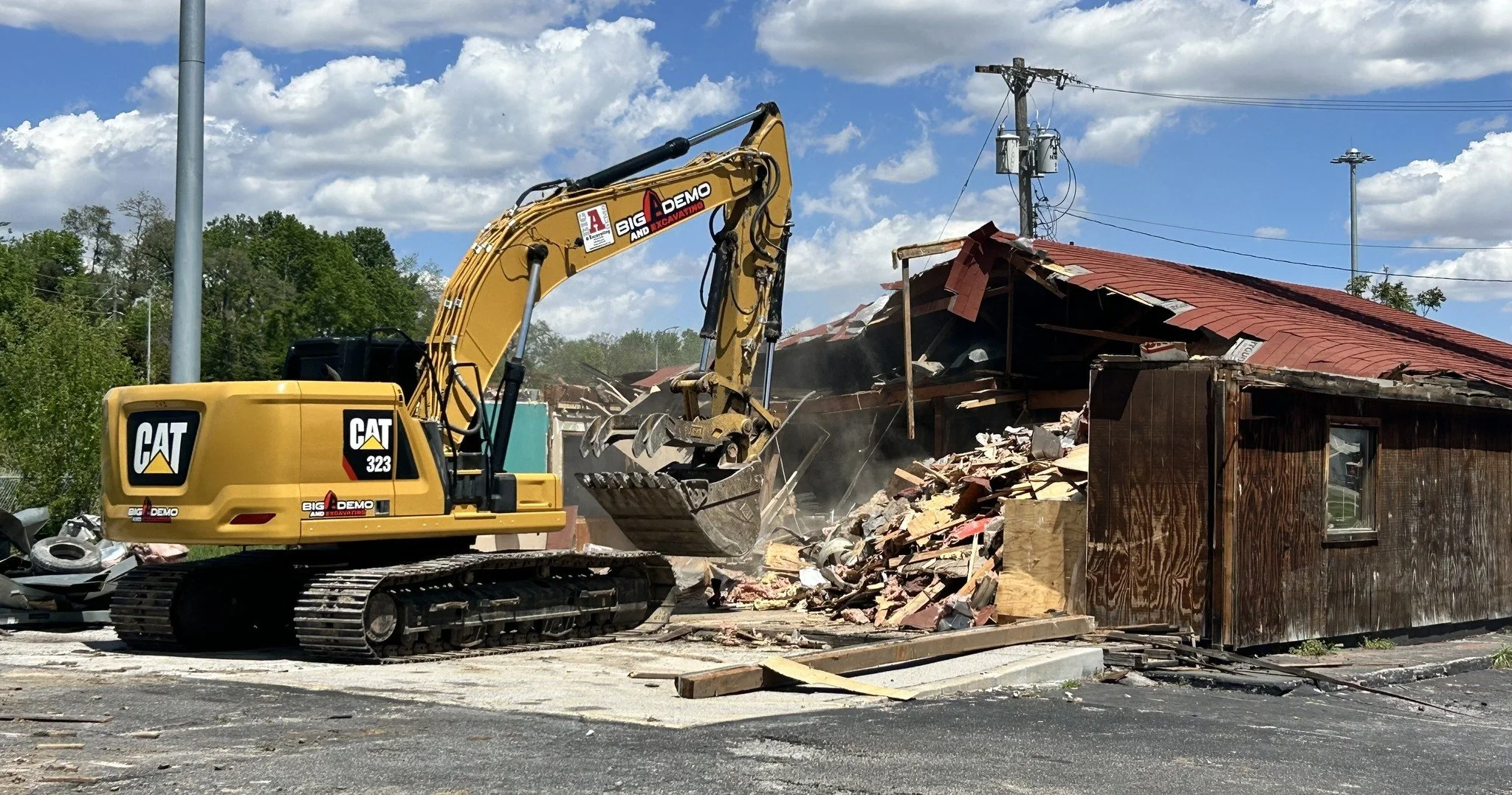 An excavator tearing down a commercial property