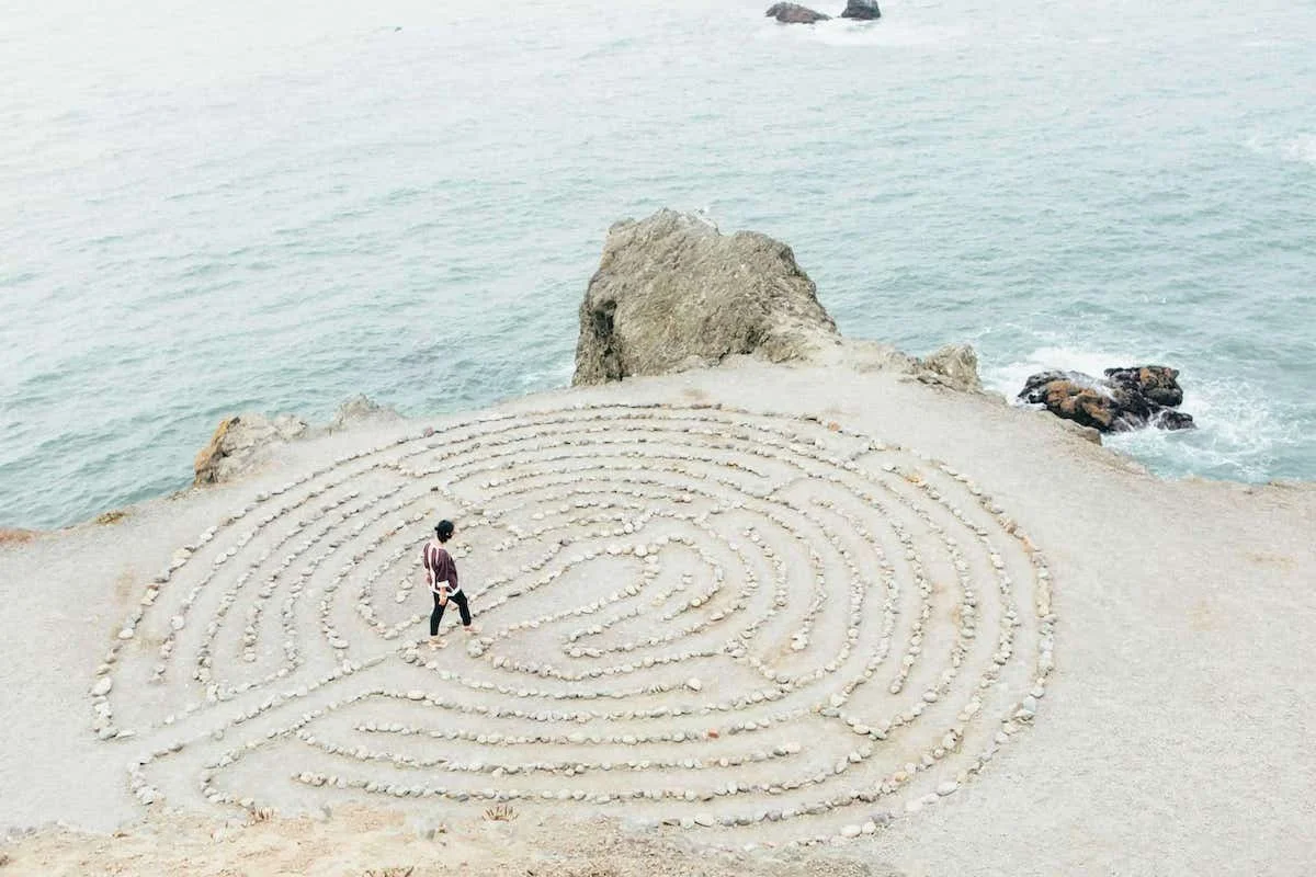 Mindful labyrinth walk on the sand near the ocean
