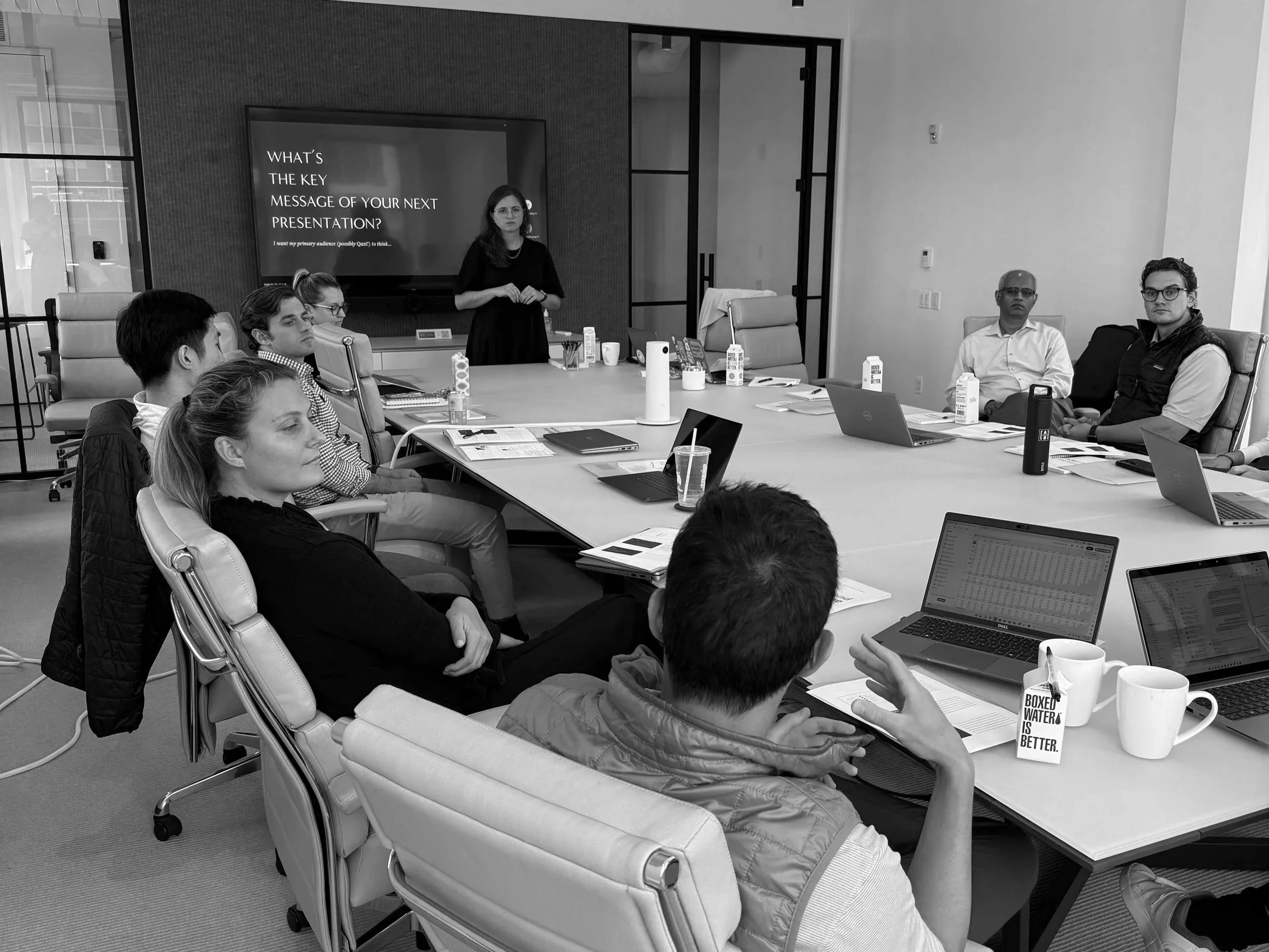 Felicity training a group of corporate leaders in a conference room.
