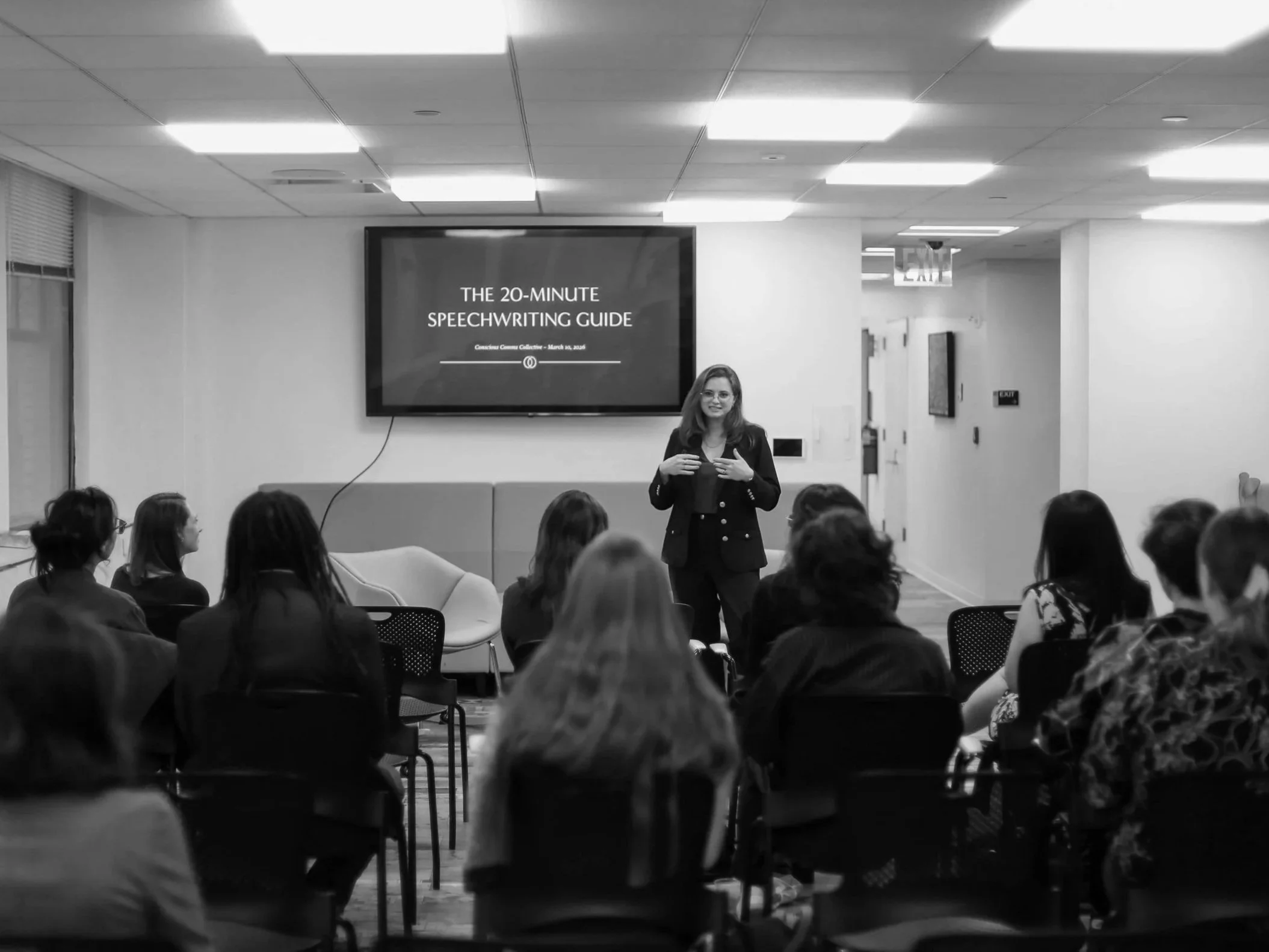 Felicity presenting to a large group in front of a big screen.
