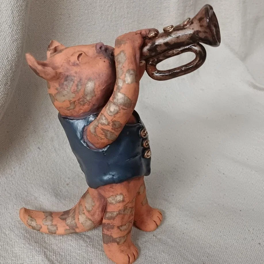 Cool cat trumpeter, red earthenware clay, fired to cone 05 with gold luster