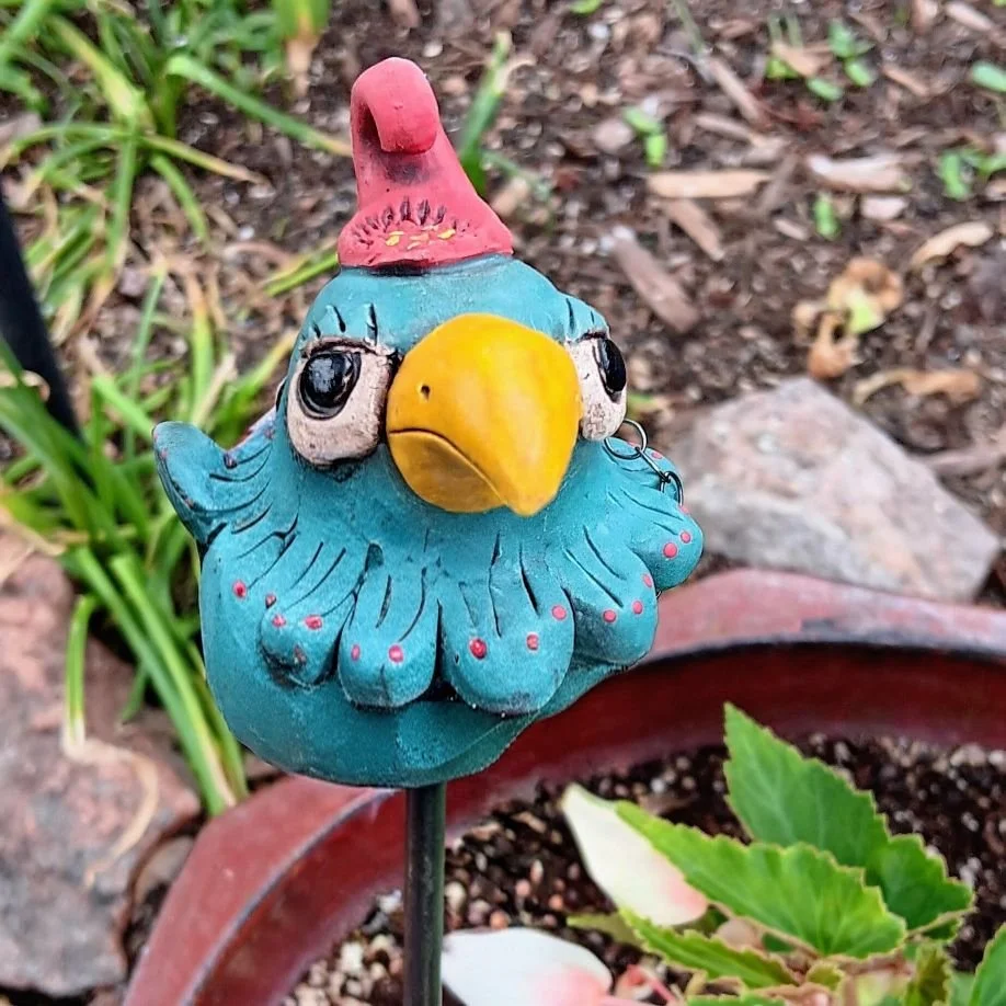Turquoise Glamour bird on a pole, white clay fired to cone 05