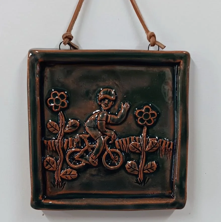 Tile with cyclist, red earthenware clay, fired to cone 05