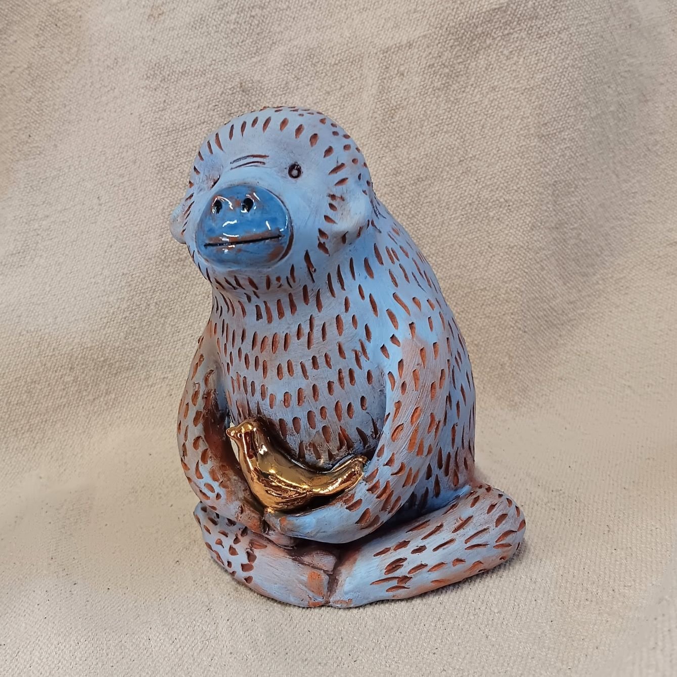 Chimp and bird, red earthenware clay, terra sigilatta, gold luster, cone 05 