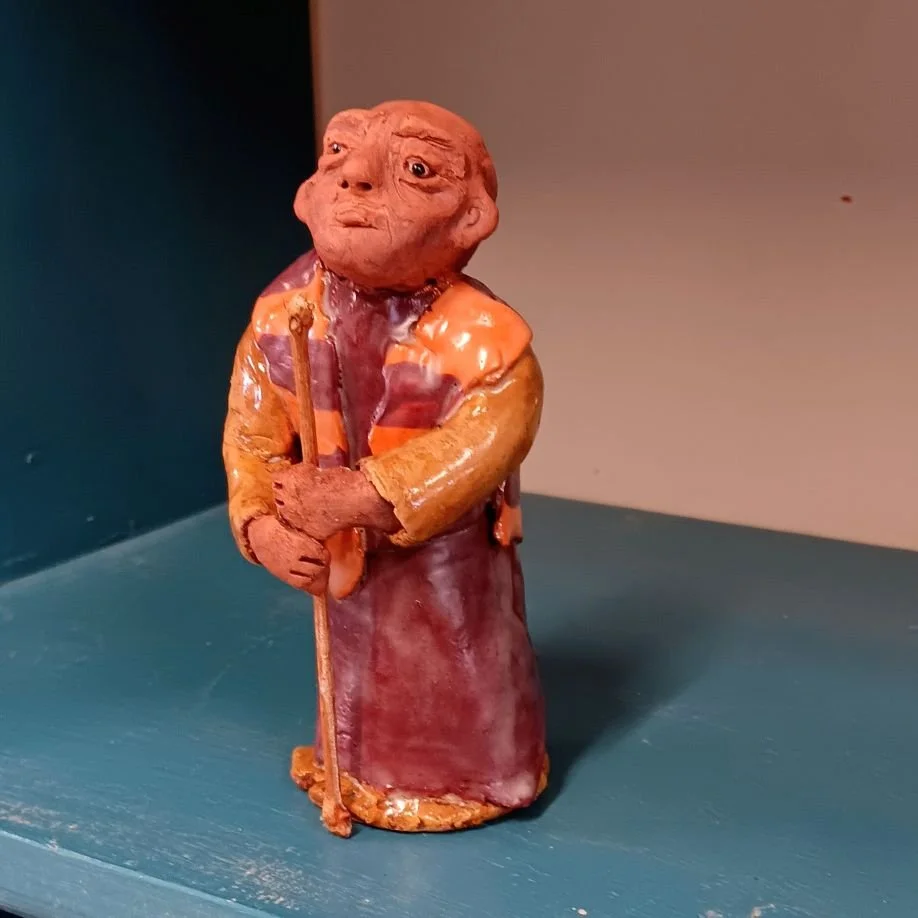 |SOLD| Walk for Peace single monk with dog, red earthenware clay fired to cone 05
