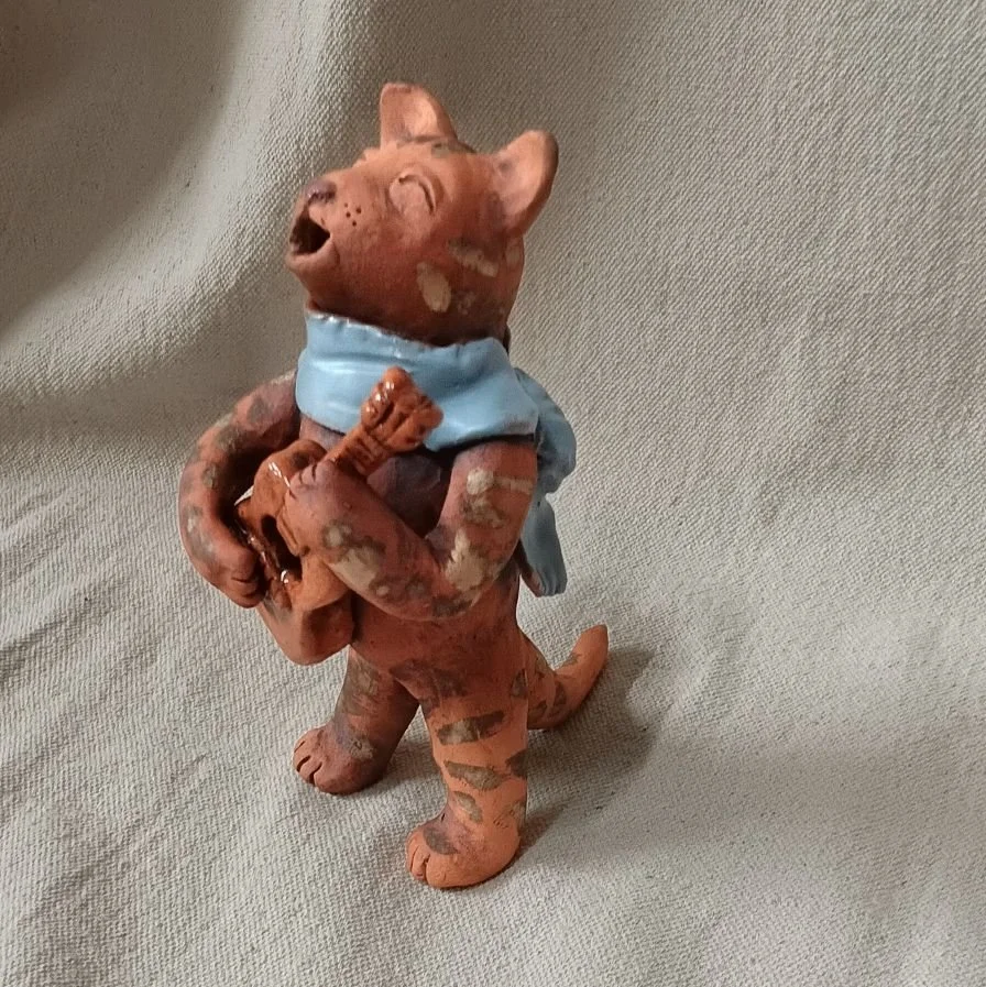 Cool cat guitarist, red earthenware clay, fired to cone 05 with gold luster