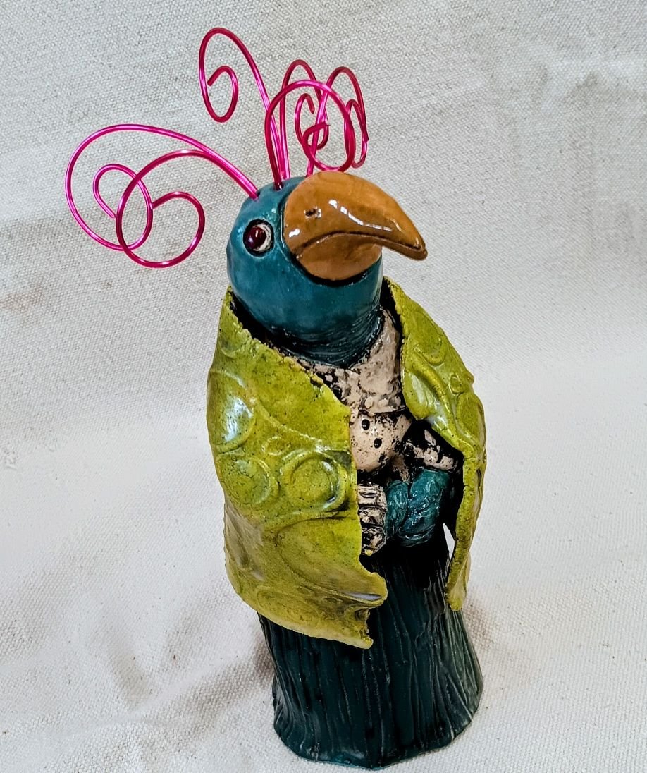 Crazy old bird, white earthenware clay, fired to cone 05 with anodized aluminum wire