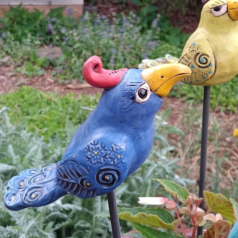 Blue Glamour bird on a pole, white clay fired to cone 05