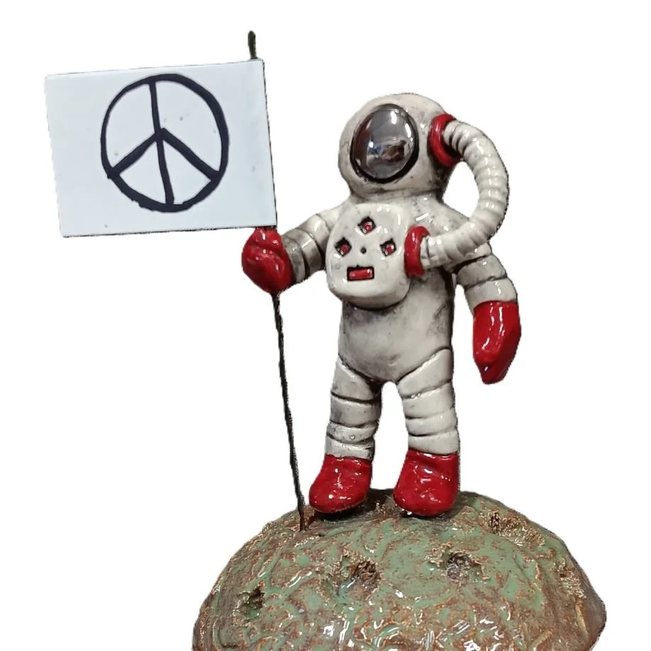  Spaceman with peace sign, white clay with platinum luster, fired to cone 05