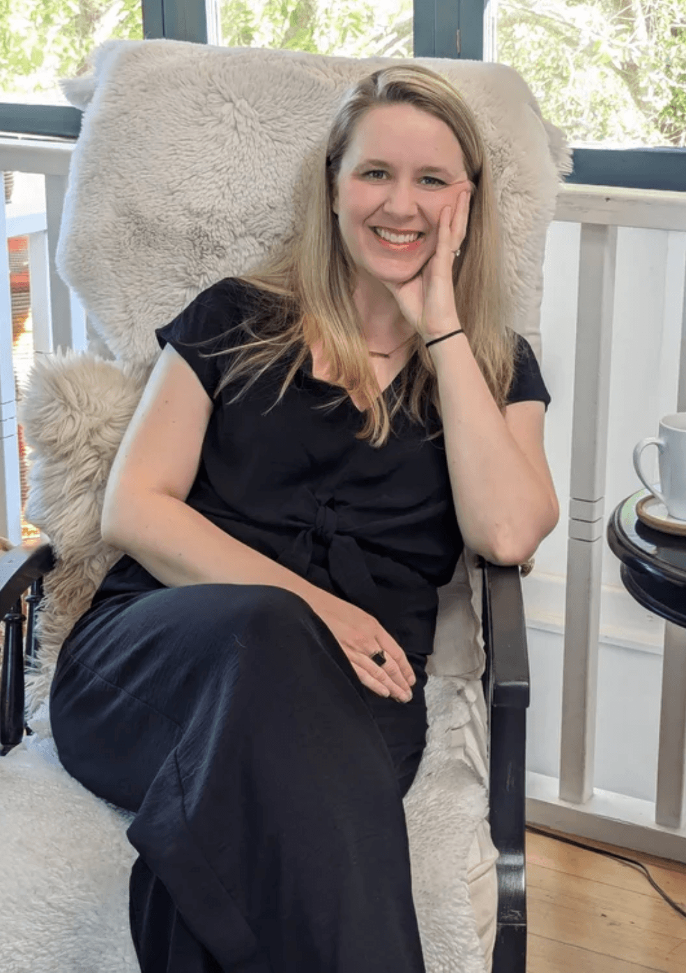 Laurel van der Toorn, Enneagram therapist sitting comfortably in a chair smiling