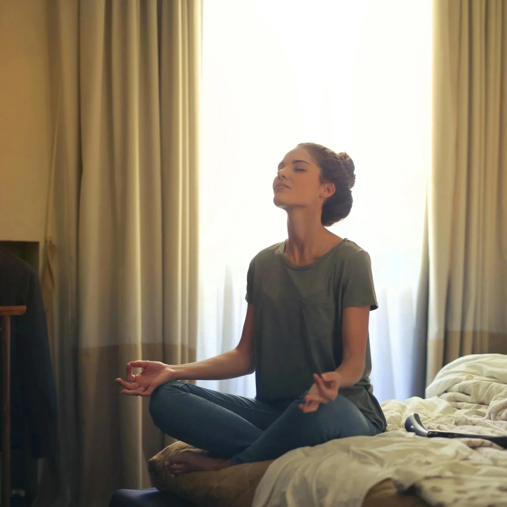person sitting meditating looking reflective representing the emotional experience of living with autoimmune disease in San Francisco and Los Angeles