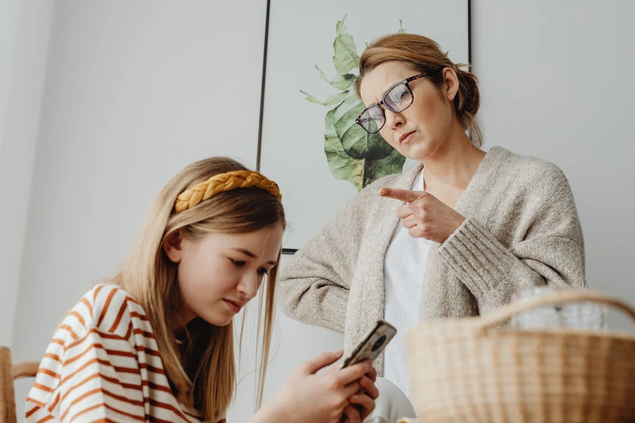 a parent pointing and frowning at her daughter. Book a consultation with a trauma therapist at Laurel Therapy Collective for EMDR therapy to heal from the long-term effects of a bullying parent in California and Florida