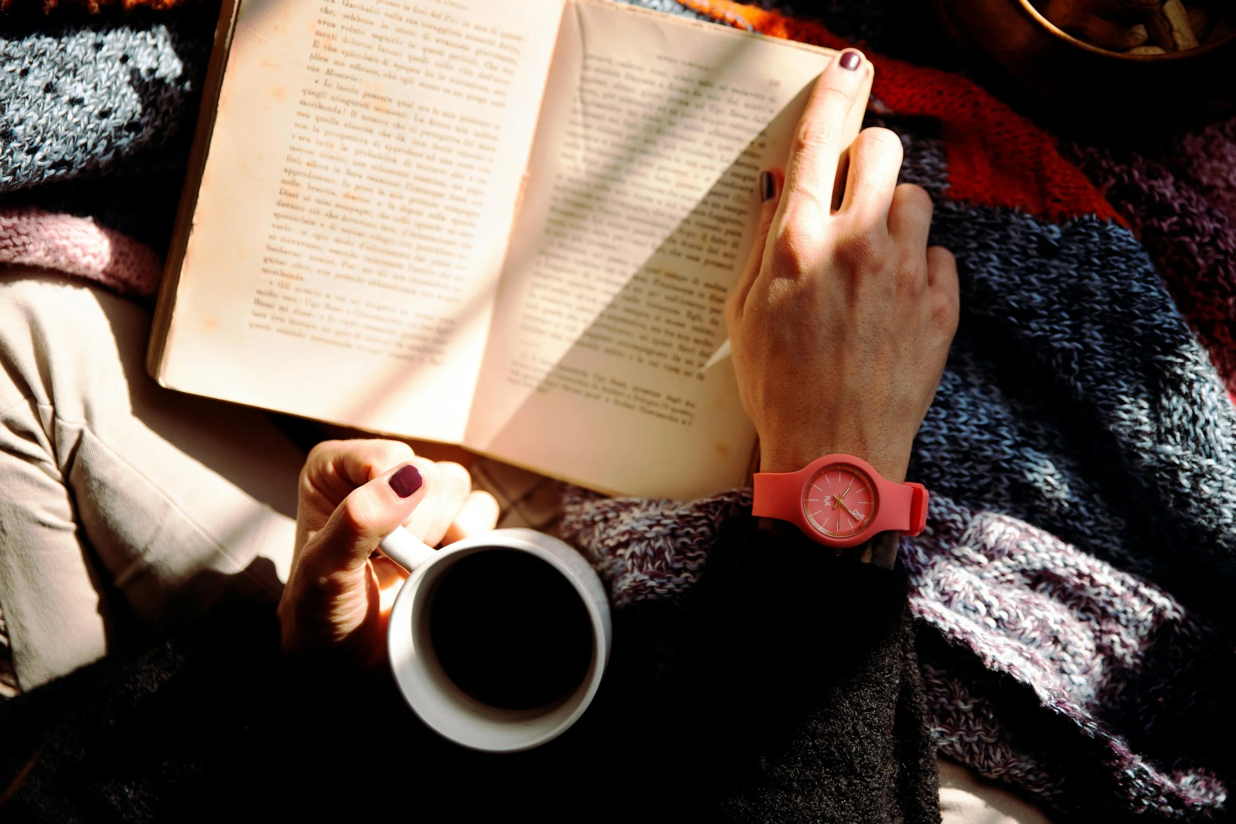 Person reading quietly while drinking tea, illustrating the difference between recovery rest and avoidance