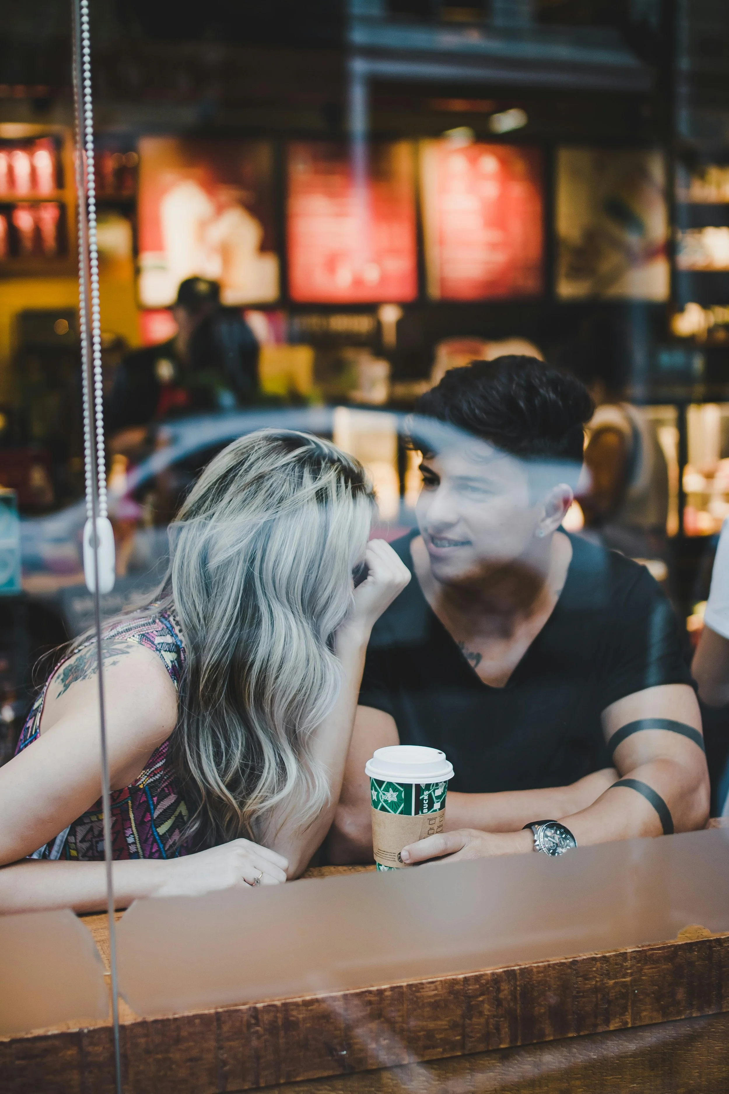 Couple sitting apart in thoughtful silence representing the painful impasse of disagreeing on having kids in couples therapy in San Francisco and Los Angeles