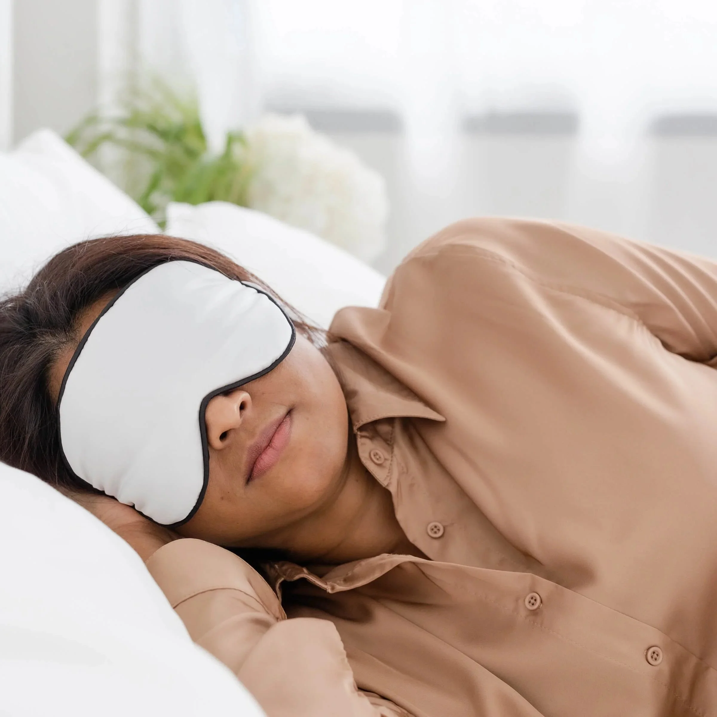 Person sleeping with an eye mask on after an EMDR therapy session, representing normal EMDR fatigue during trauma processing