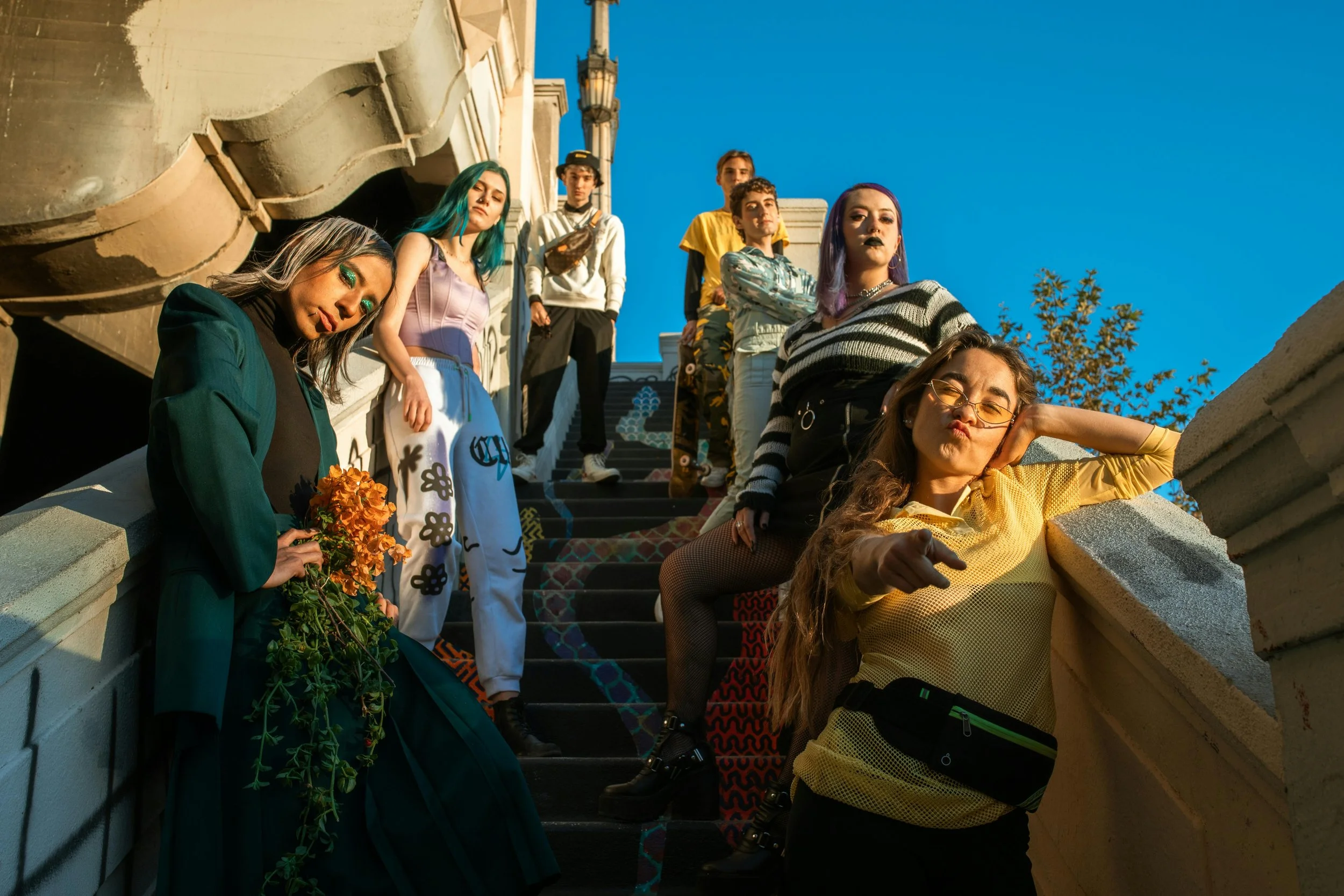 friends posing for a glam shot on a staircase, representing what it looks like to be a trusted ally to the trans community in 2026