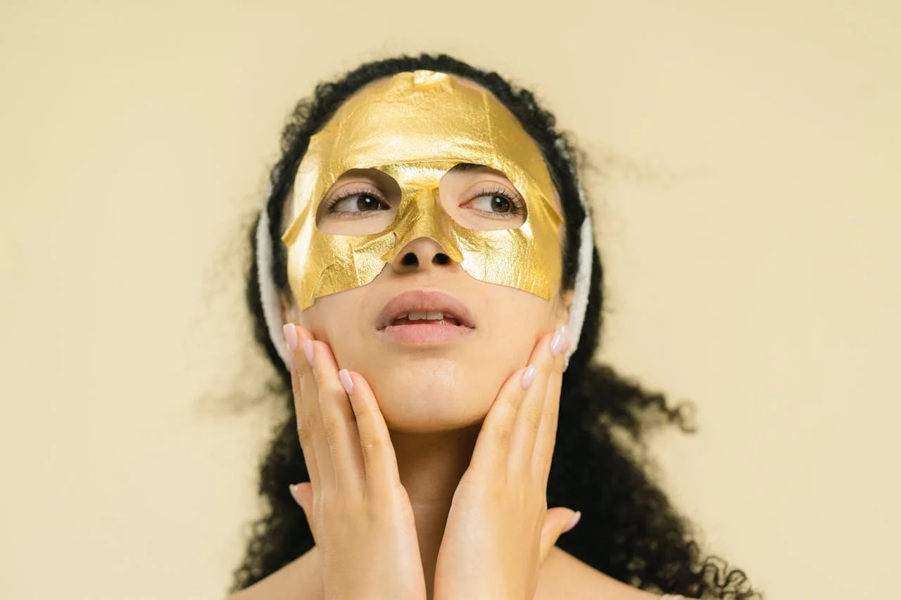 a person wearing a gold beauty facemask  looking relaxed, representing the relief of unmasking supported by an AuDHD therapist and neurodivergent affirming therapist in California.
