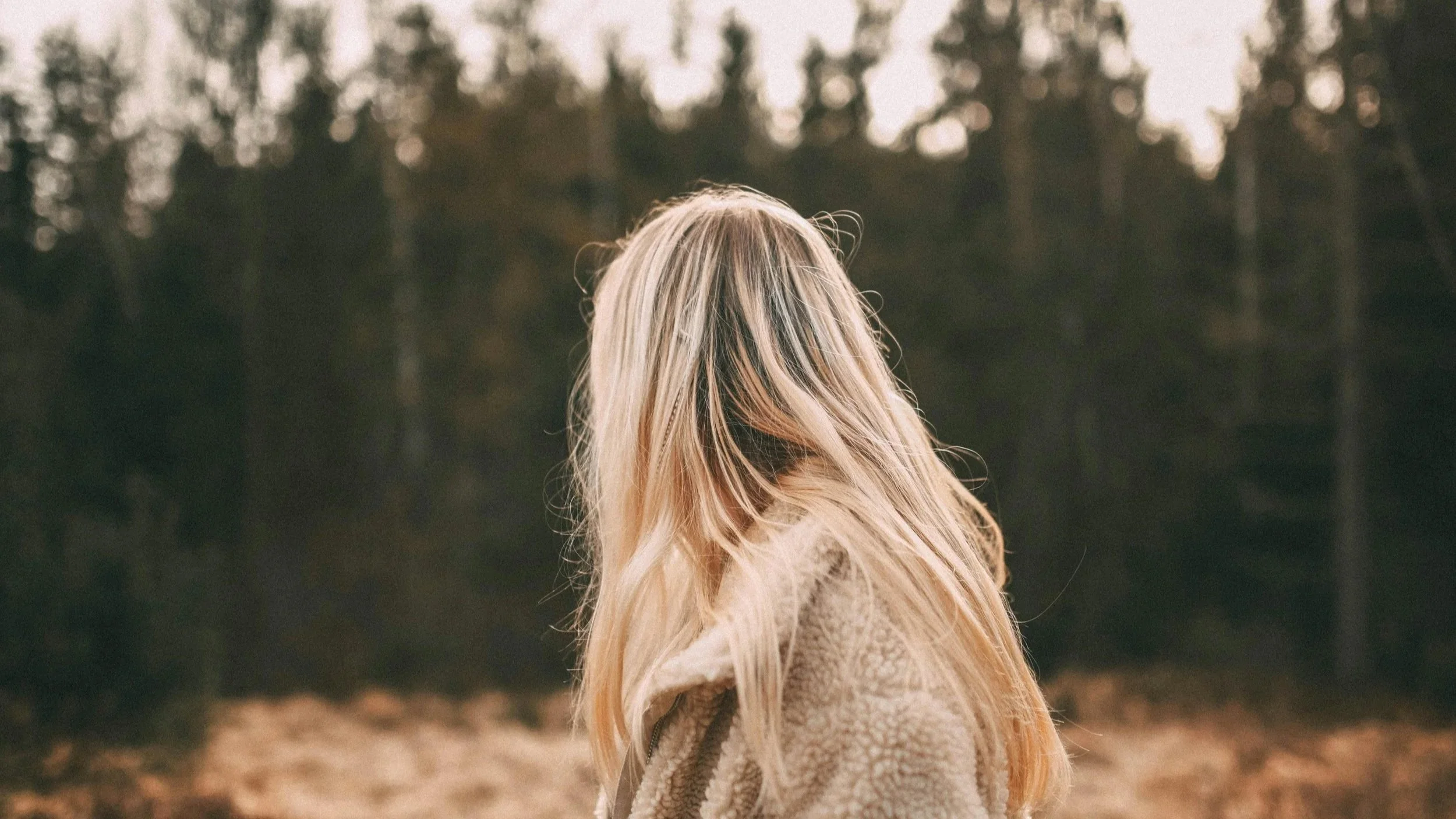 Person thinking about a packed calendar with quiet anxiety, representing the over-scheduled patterns that bring high-achievers to burnout therapy