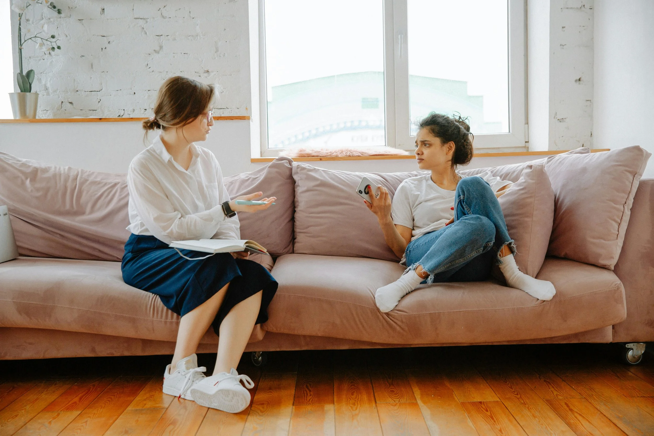 a therapist and client sitting on a couch, representing the unexpected emotional release that can come up as the nervous system thaws during EMDR