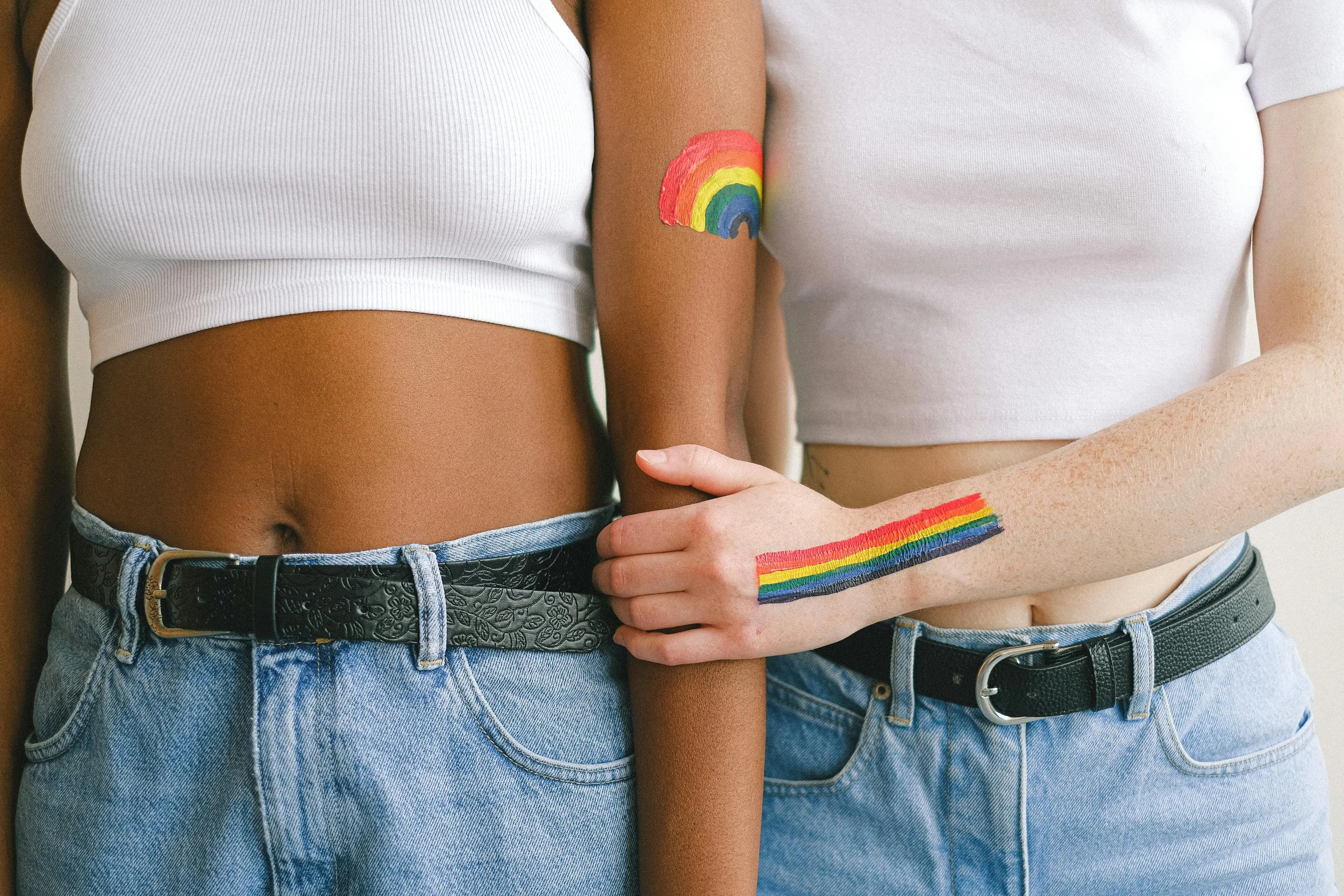 a couple decorated with rainbow paint celebrating LGBT pride and identity, symbolizing the affirming and inclusive approach of LGBT therapy at Laurel Therapy Collective