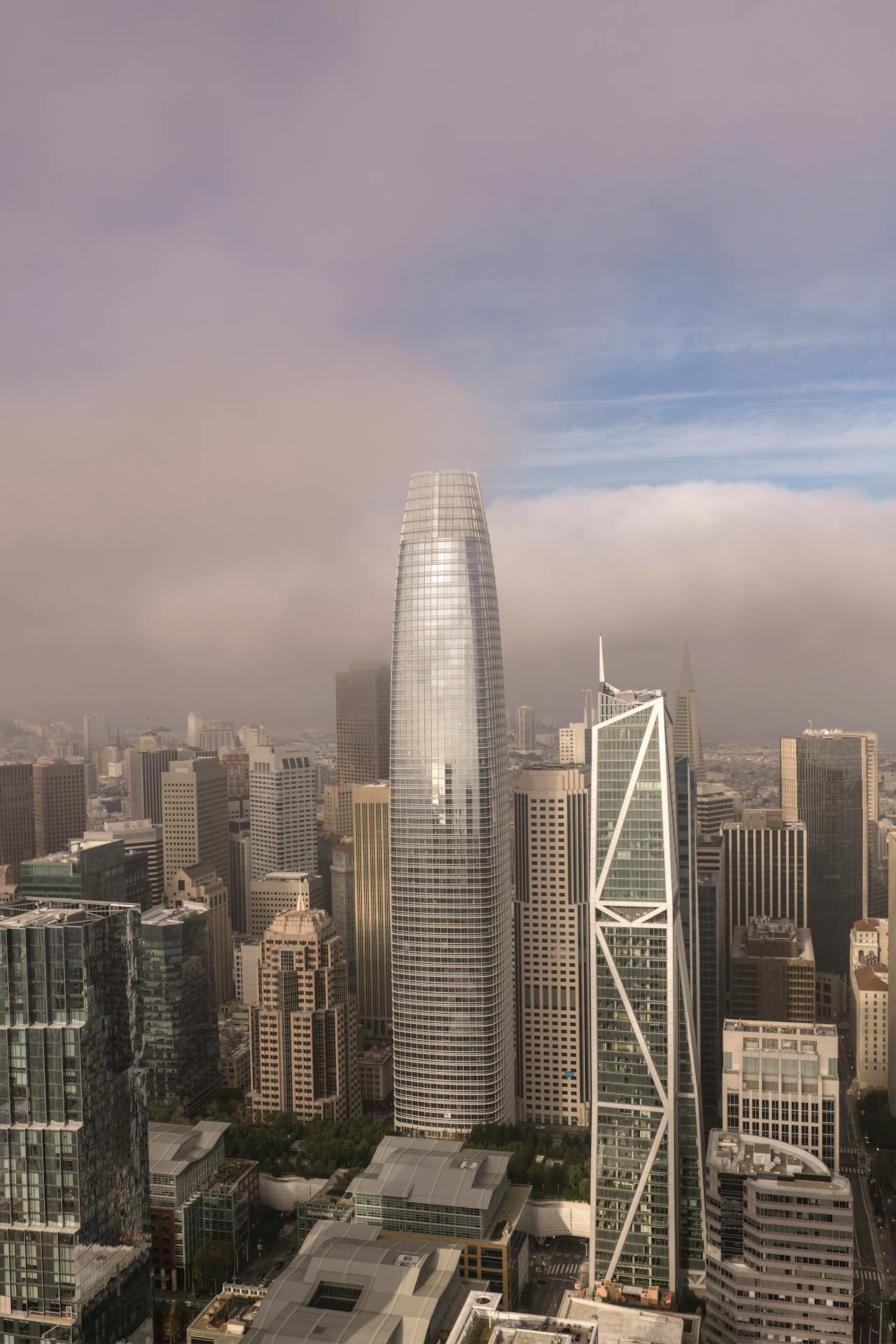 a photo of salesforce tower in the fog representing the fog of trauma and how working with a great emdr therapist or trauma therapist can clear the fog and help you achieve at work
