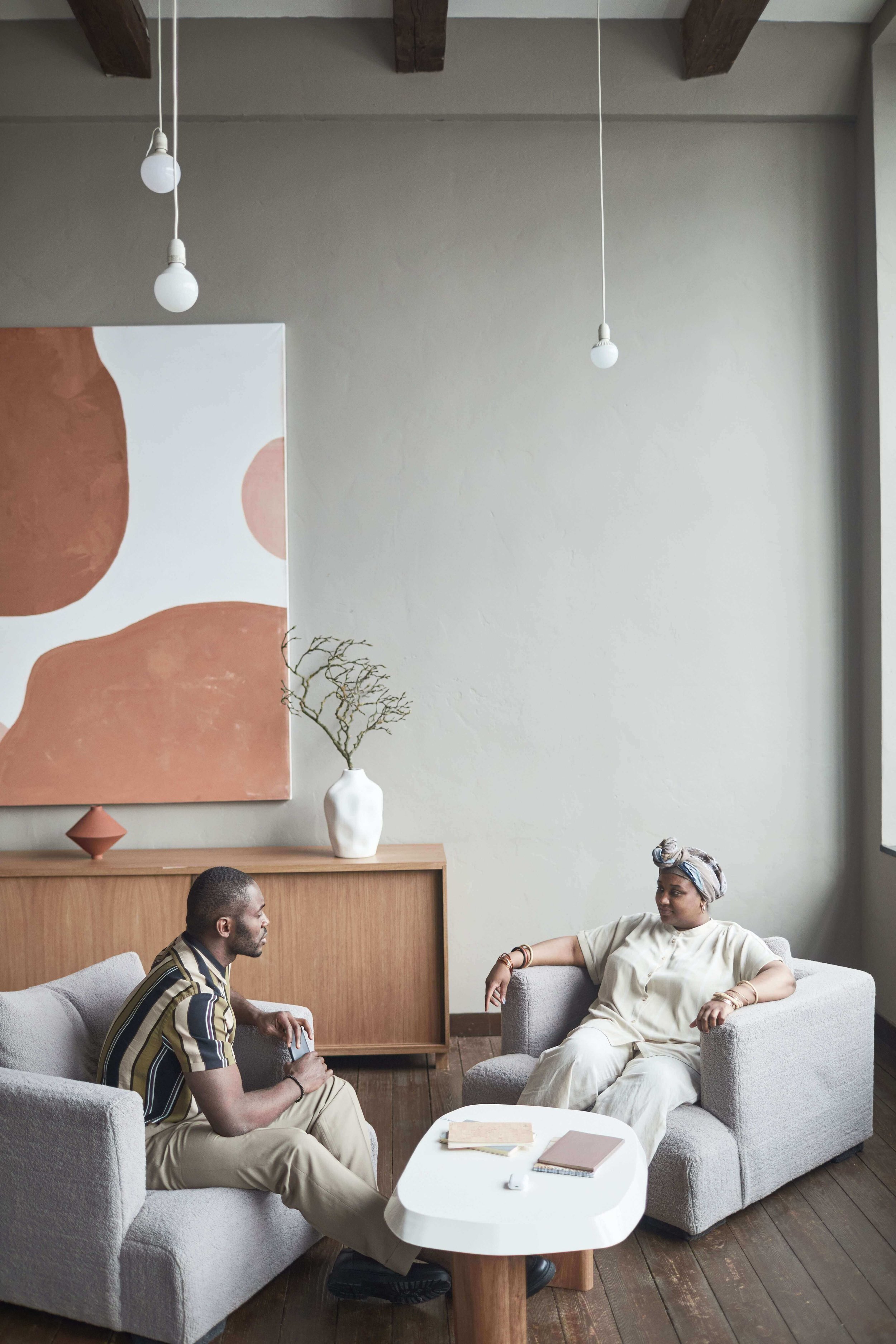 Two people talking in a stylized therapy office representing EMDR trauma therapy in Los Angeles