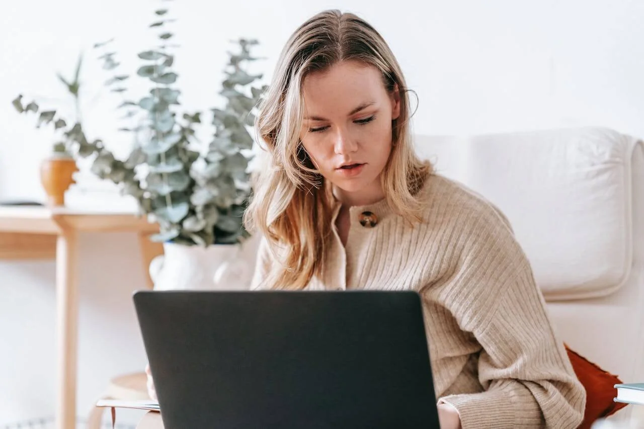 Woman working on a laptop representing deep work and productivity strategies for burnout prevention