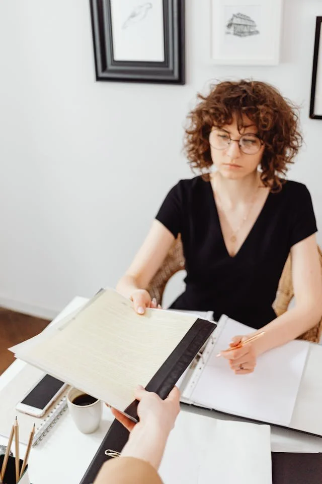 Professional at a desk reviewing documents representing performance review anxiety in high-pressure careers