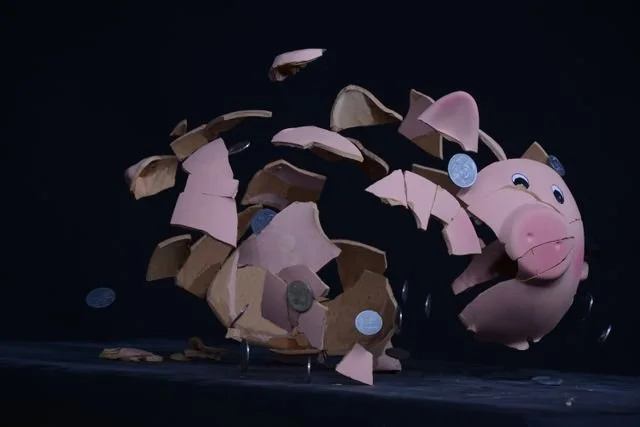 Broken piggy bank representing the financial stress and trauma that keeps the nervous system in a state of anxiety