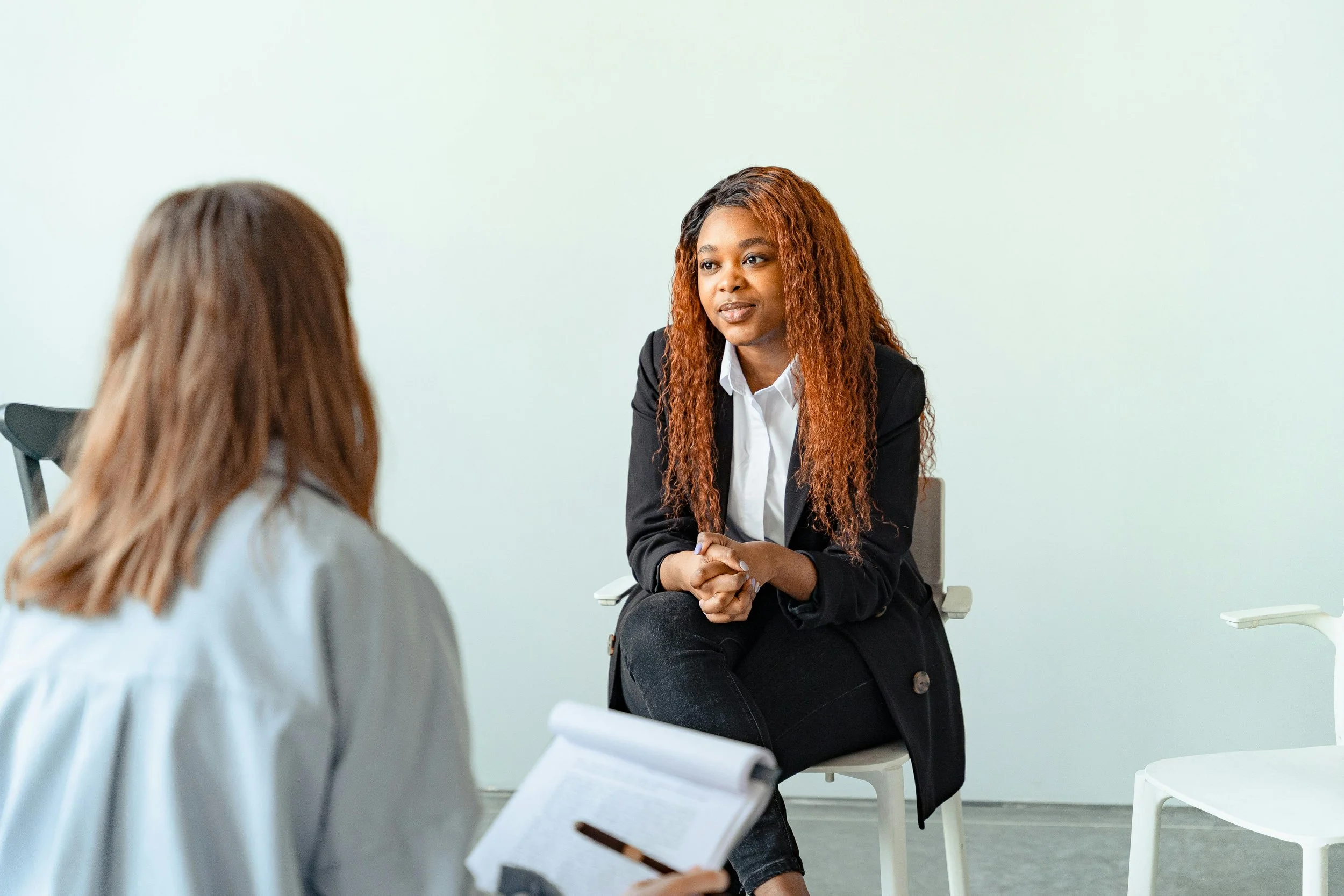 Person sitting in a calm therapy session representing EMDR trauma processing without requiring detailed disclosure