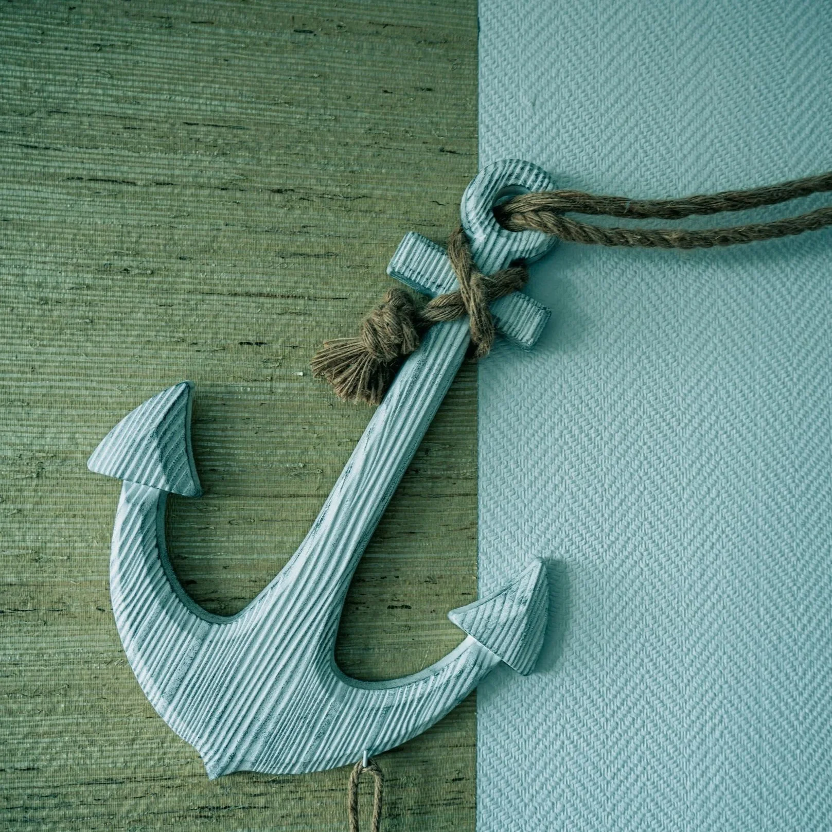 a small blue wooden anchor on a string representing the start of emdr therapy intensive los angeles or san francisco