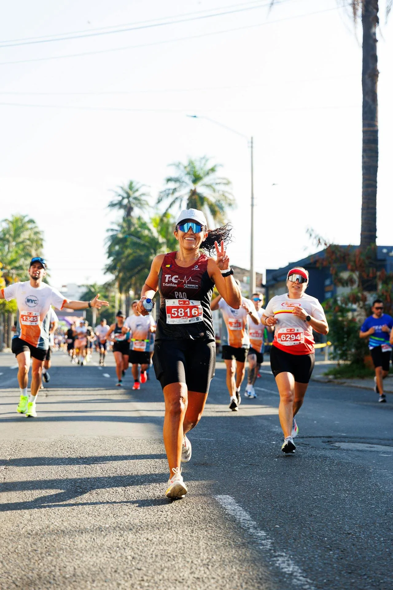 a person running a marathon with palm trees in the background representing the los angeles marathon and its ties to trauma healing and resilience through emdr therapy