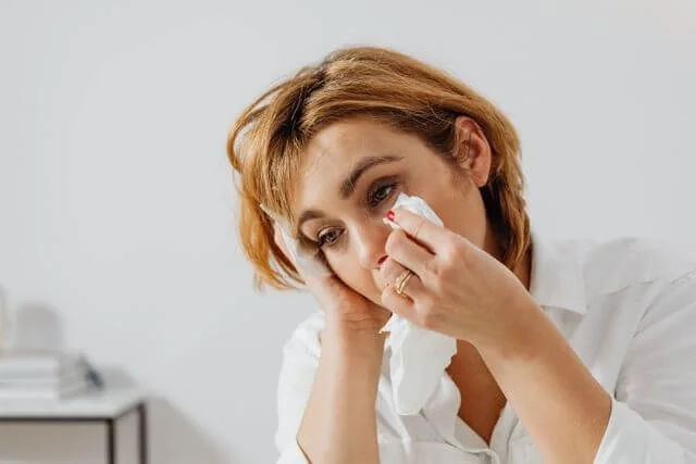 Person allowing themselves to cry representing healthy emotional release as part of burnout recovery and holistic therapy