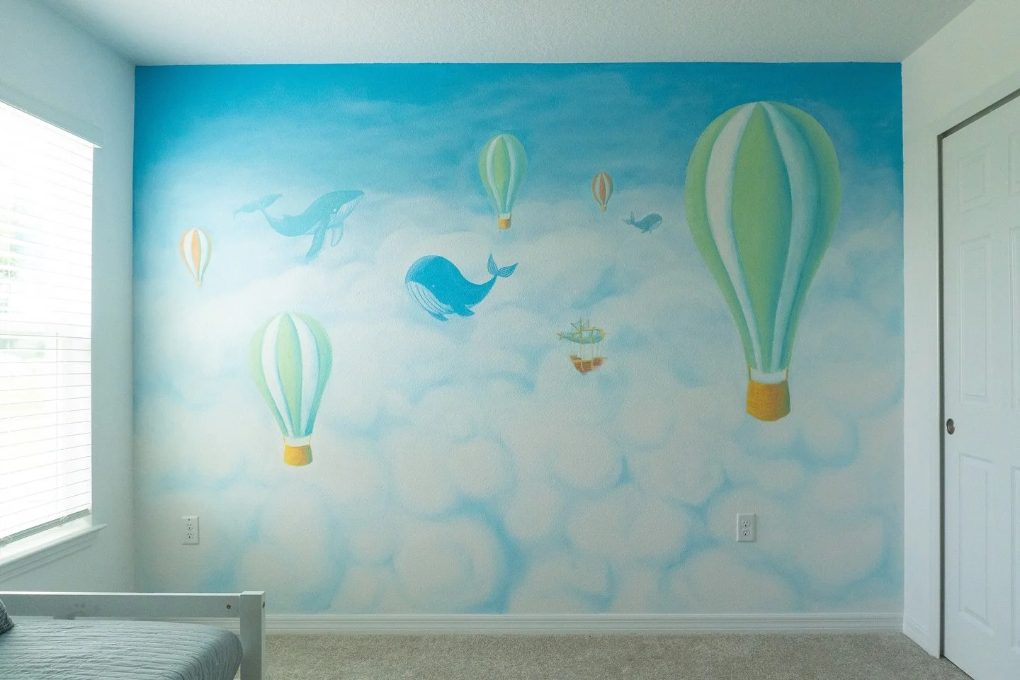 My first nursery mural is complete! There&rsquo;s just something about hot air balloons and whales that has the baby industry in a chokehold idk
We added a fun lil &ldquo;friendly merchant air ship&rdquo; to add more whimsy to whatever story this tel