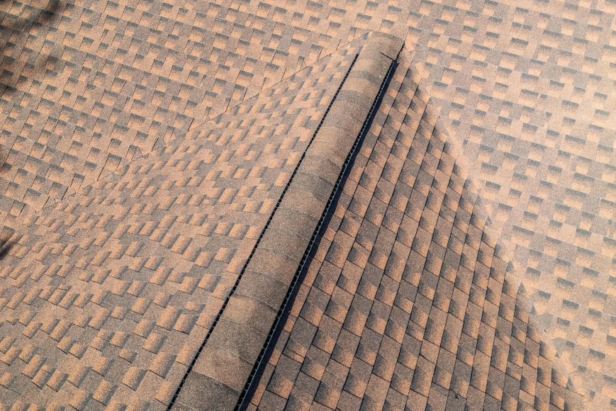 roof shingles lifted and damaged by strong wind during a storm