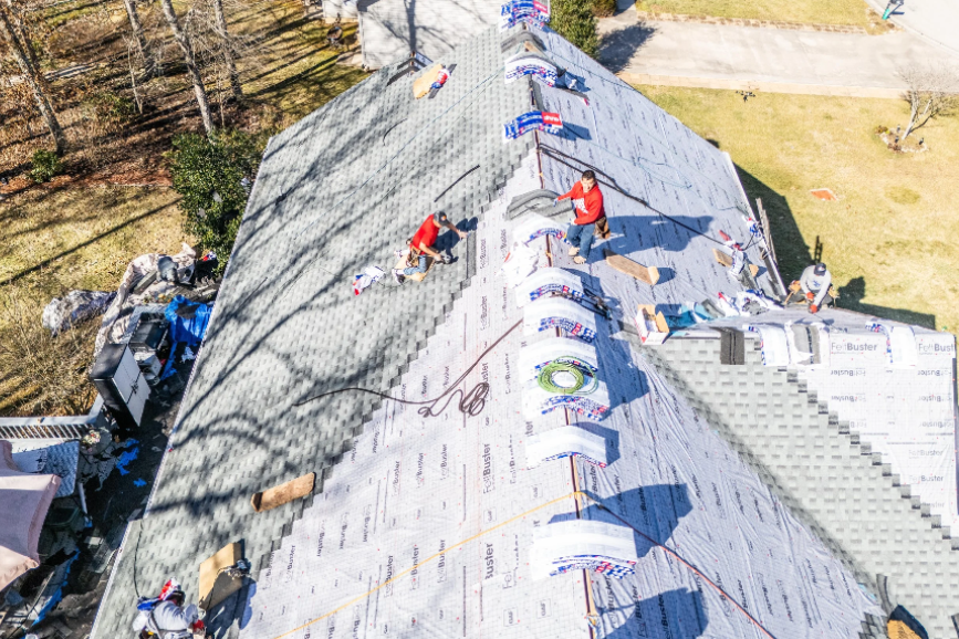 professional roofing contractor inspecting residential roof