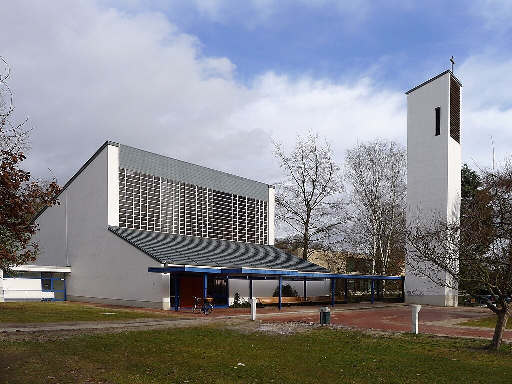 White and grey church building with free-standing bell tower