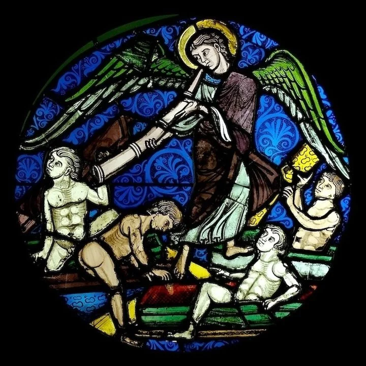 Stained glass of angel blowing horn and four men rising from their graves