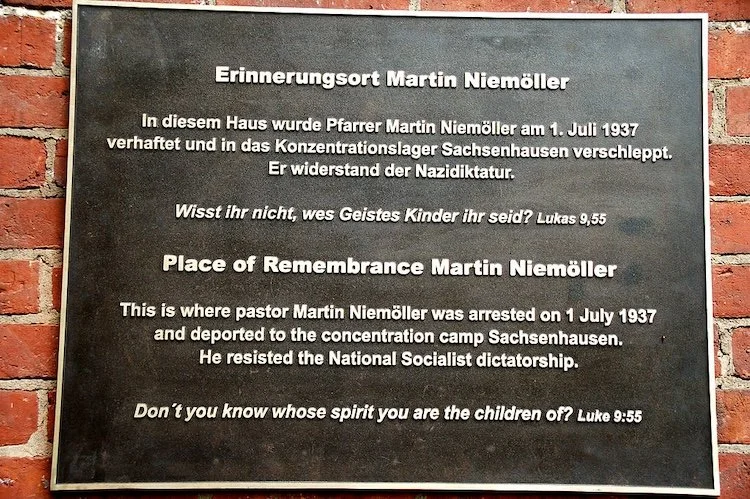 Plaque on red brick wall in memory of Pastor Martin Niemöller
