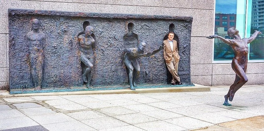 Human figure bursting free from a metallic wall